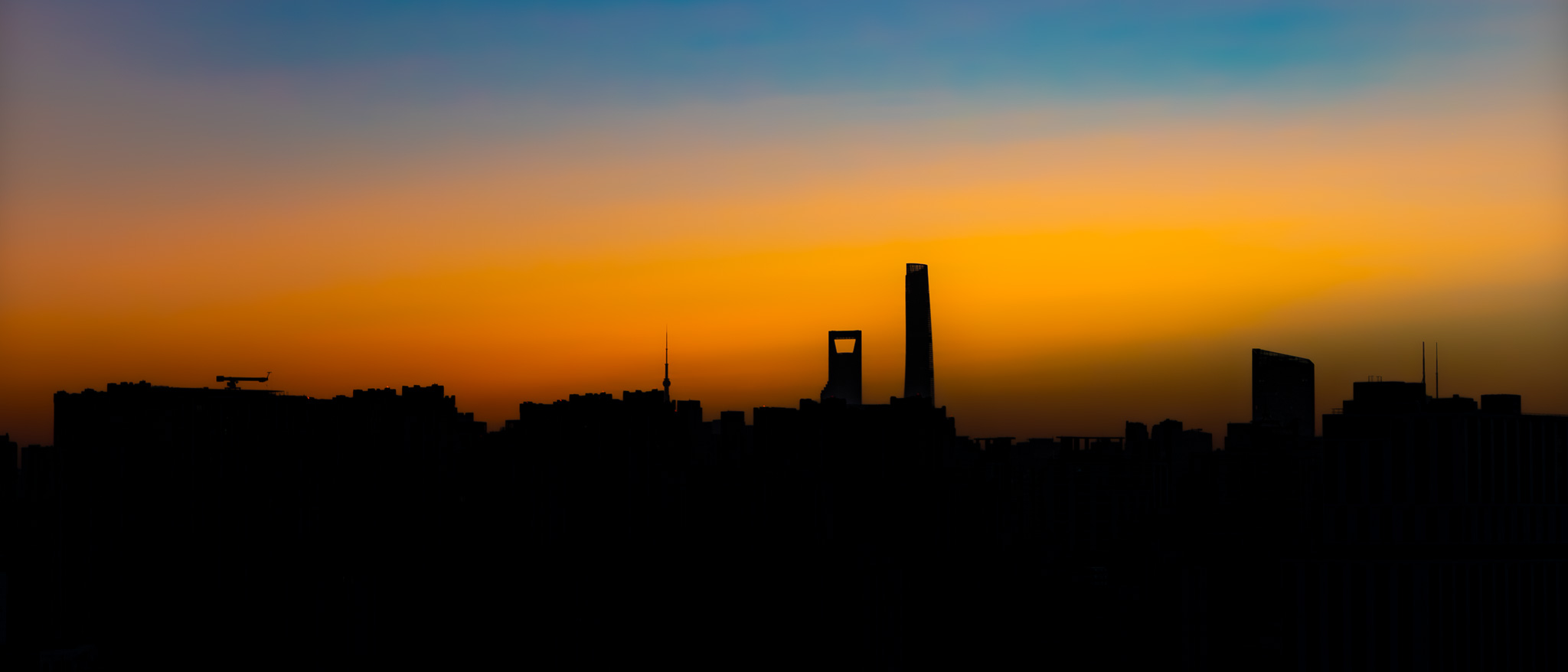 Panorama de Shanghai : silhouettes des tours sur un ciel orange et bleu, photographié en novembre 2025.